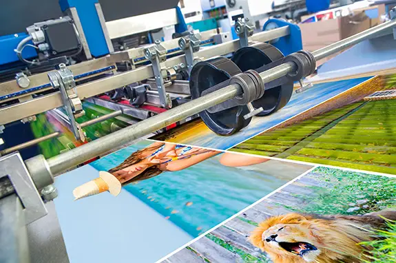 A closeup of a large format printer printing