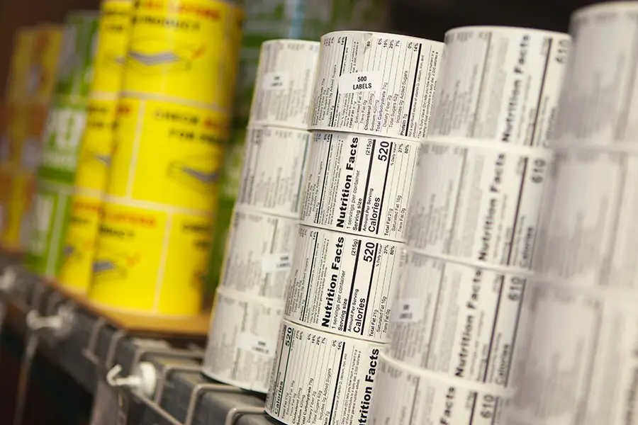 Stacks of printed labels on a warehouse shelf